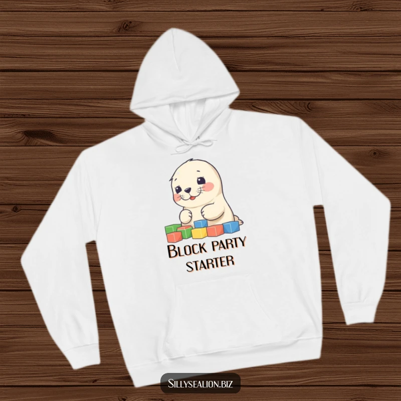 Funny sea lion pup hoodie depicting a cute, happy pup focused on sorting a pile of colorful blocks, radiating pure joy.